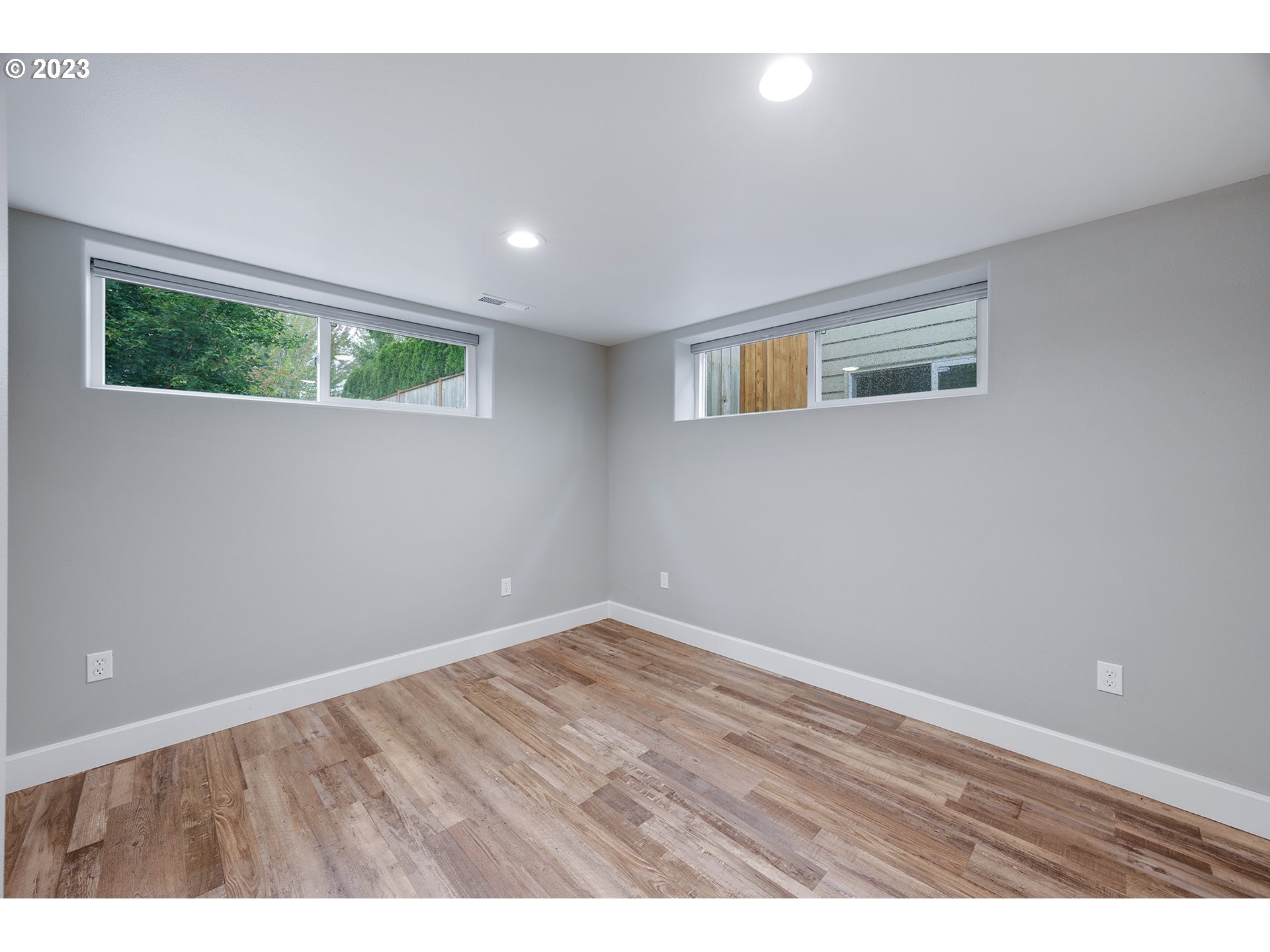 1427 Southeast 109th Avenue Portland, OR 97216 - Photo 29 of 44 a view of an empty room with wooden floor and a window