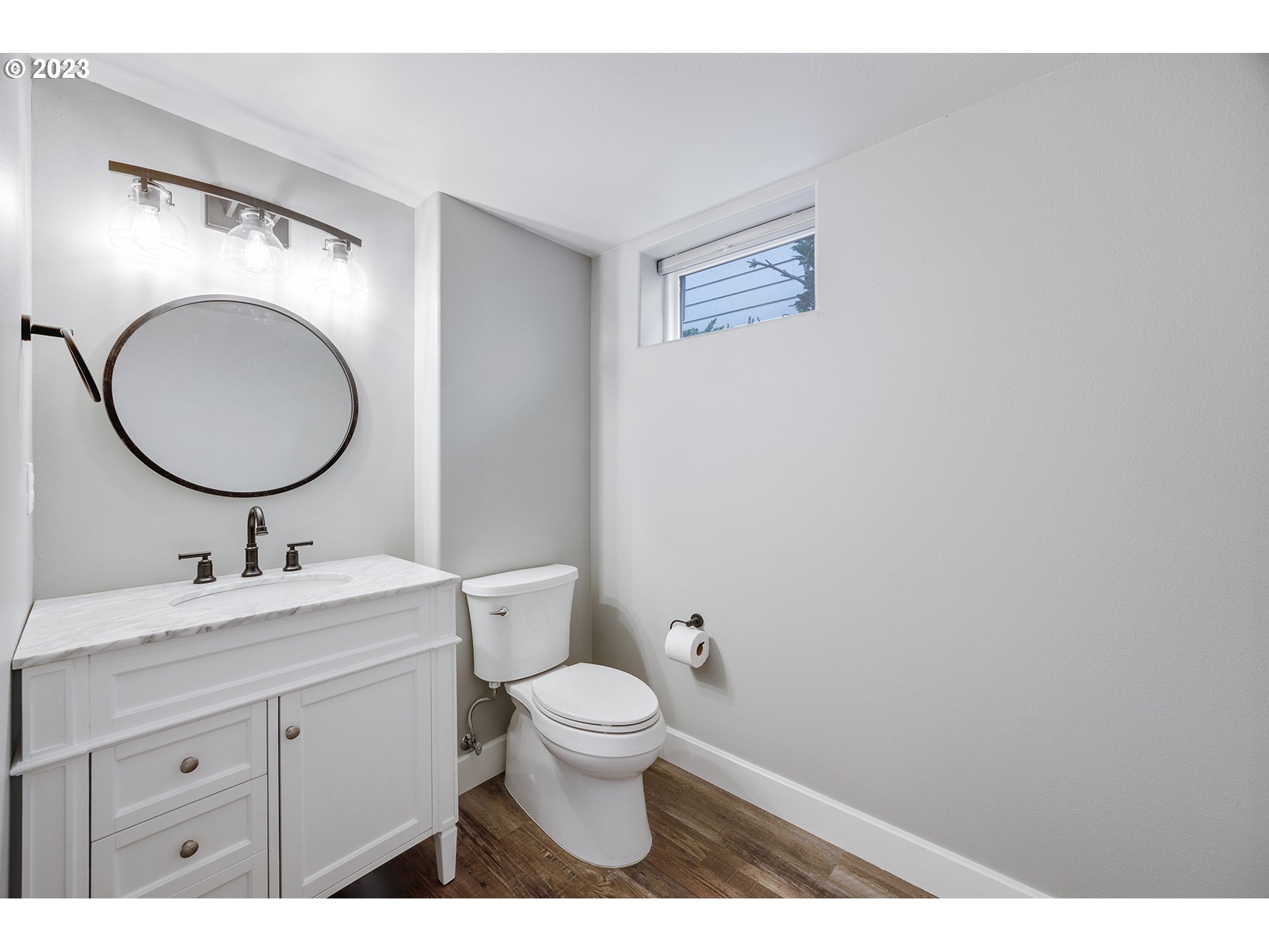 1427 Southeast 109th Avenue Portland, OR 97216 - Photo 35 of 44 a bathroom with a toilet sink vanity and mirror