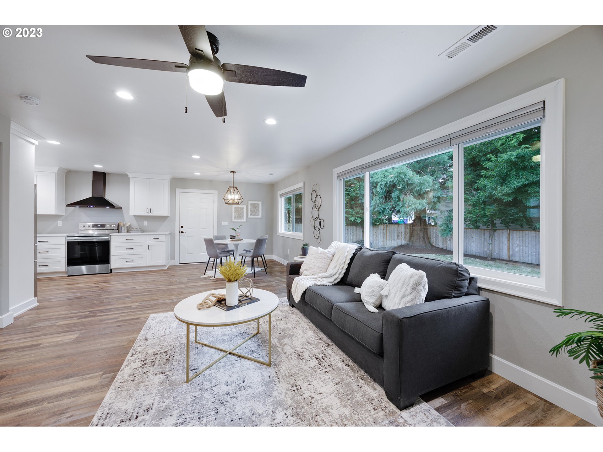 1427 Southeast 109th Avenue Portland, OR 97216 - Photo 10 of 44 a living room with furniture a fireplace and a large window