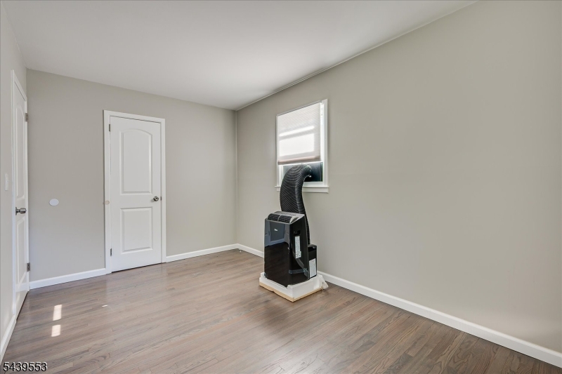 15 Woodmere Street Raritan, NJ 08869 - Photo 13 of 16 a view of an empty room with wooden floor