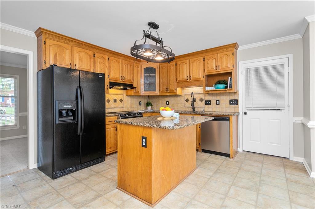 3103 Spring Mill Road Greensboro, NC 27406 - Photo 12 of 44 Bright kitchen with access to the garage. Bring the groceries in and place them where they belong right away.