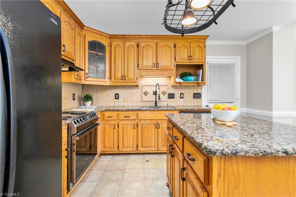 3103 Spring Mill Road Greensboro, NC 27406 - Photo 16 of 44 Kitchen has granite countertops and classy blacksplash