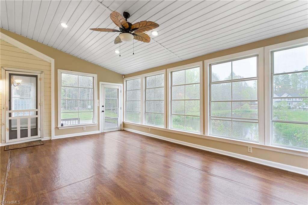 3103 Spring Mill Road Greensboro, NC 27406 - Photo 18 of 44 This 3 season room is awaiting your furnishings. Previous owner had table and chairs with lounger and sofa. It all fits in here. It's an additional space to enjoy with gorgeous views. Fall in love.