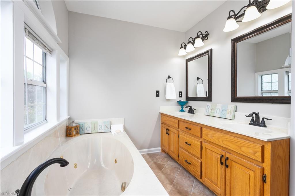 3103 Spring Mill Road Greensboro, NC 27406 - Photo 24 of 44 Primary bath has dual sinks and soaker tub.