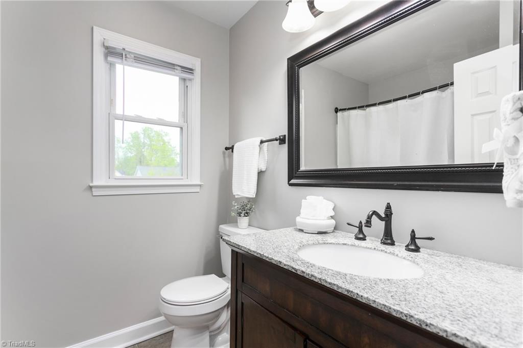 3103 Spring Mill Road Greensboro, NC 27406 - Photo 27 of 44 Hall bath has easy to clean tub shower combo and views of the pond