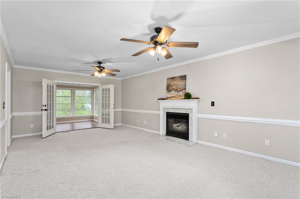 3103 Spring Mill Road Greensboro, NC 27406 - Photo 8 of 44 Very spacious living room with french door access to 3 seasons room