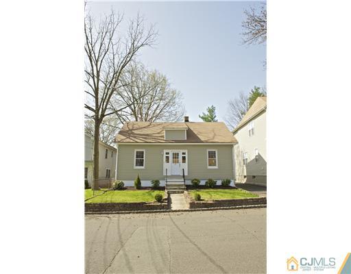 33 Meckes Street Springfield, NJ 07081 - Photo 2 of 25 a view of a white house next to a yard with large trees