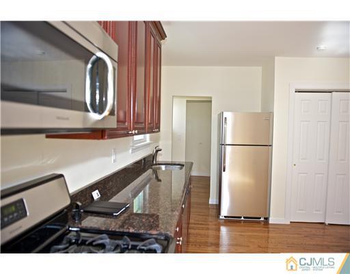 33 Meckes Street Springfield, NJ 07081 - Photo 11 of 25 a kitchen with a refrigerator and a microwave