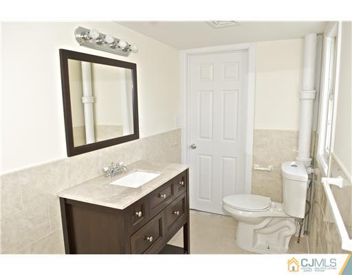 33 Meckes Street Springfield, NJ 07081 - Photo 22 of 25 a bathroom with a sink vanity mirror and toilet
