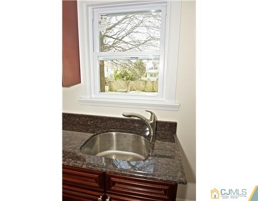 33 Meckes Street Springfield, NJ 07081 - Photo 10 of 25 a bathroom with a granite countertop sink and window