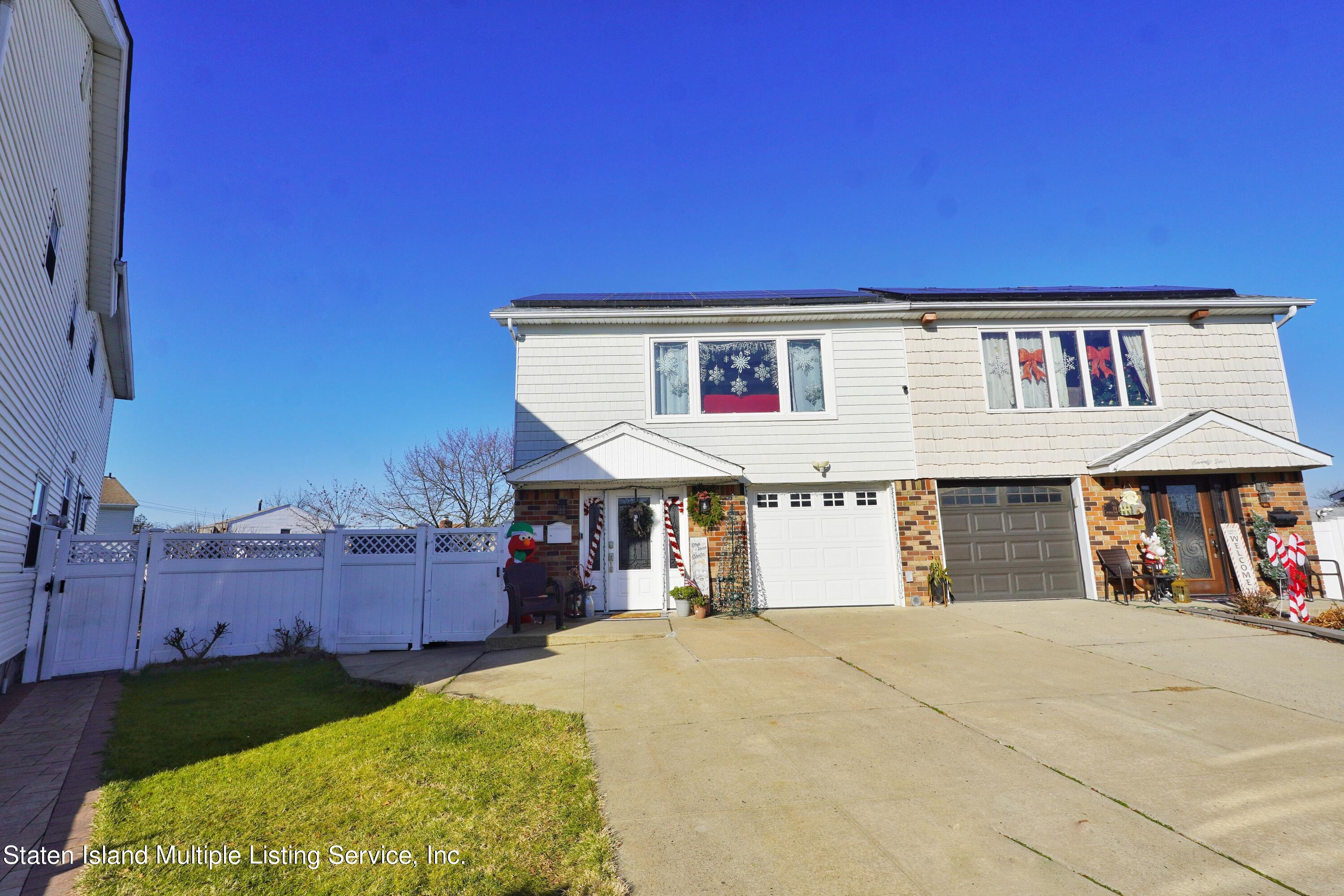 72 Middle Loop Road Staten Island, NY 10308 - Photo 1 of 38 a front view of a house with a garden