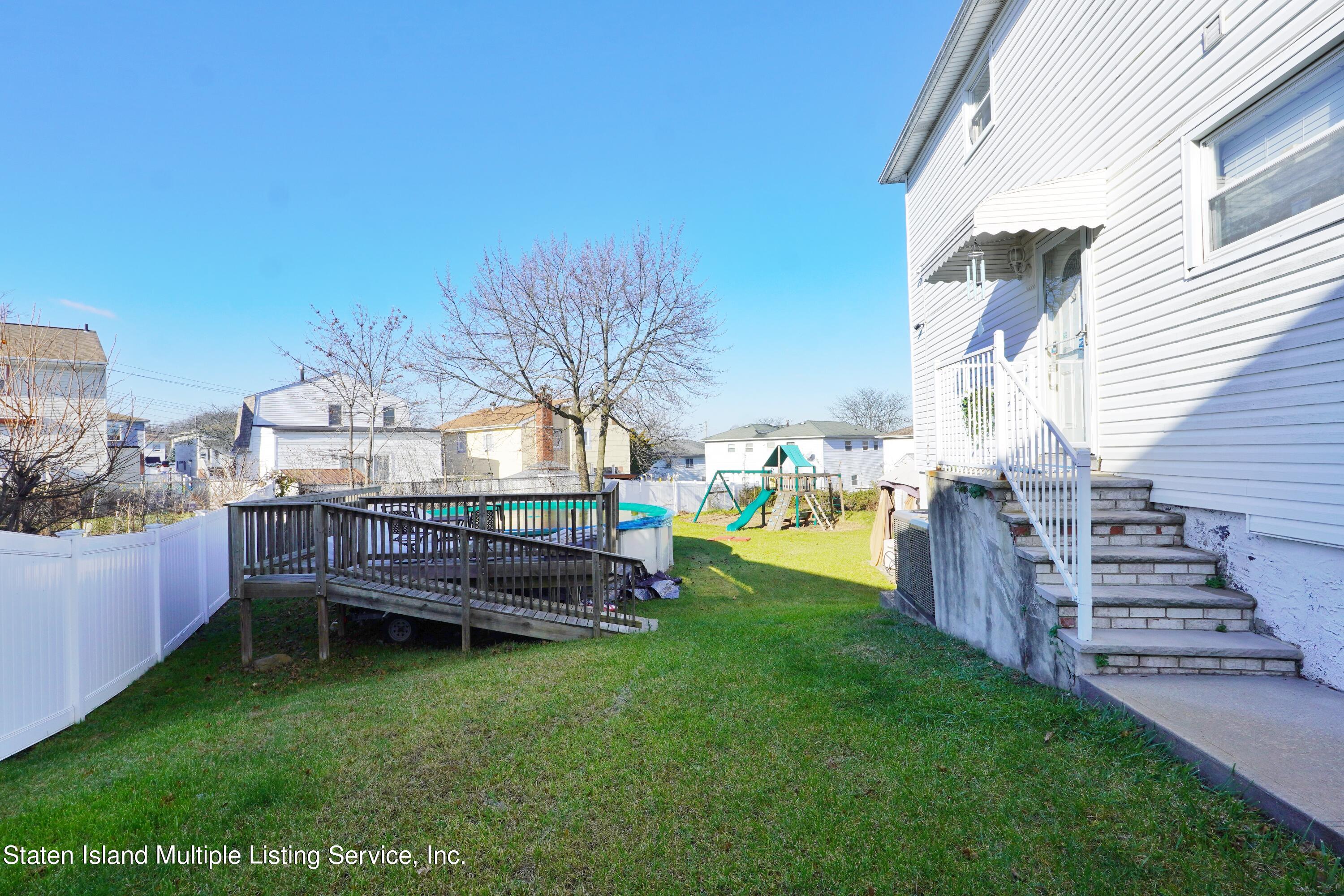 72 Middle Loop Road Staten Island, NY 10308 - Photo 14 of 38 a view of a backyard with sitting area