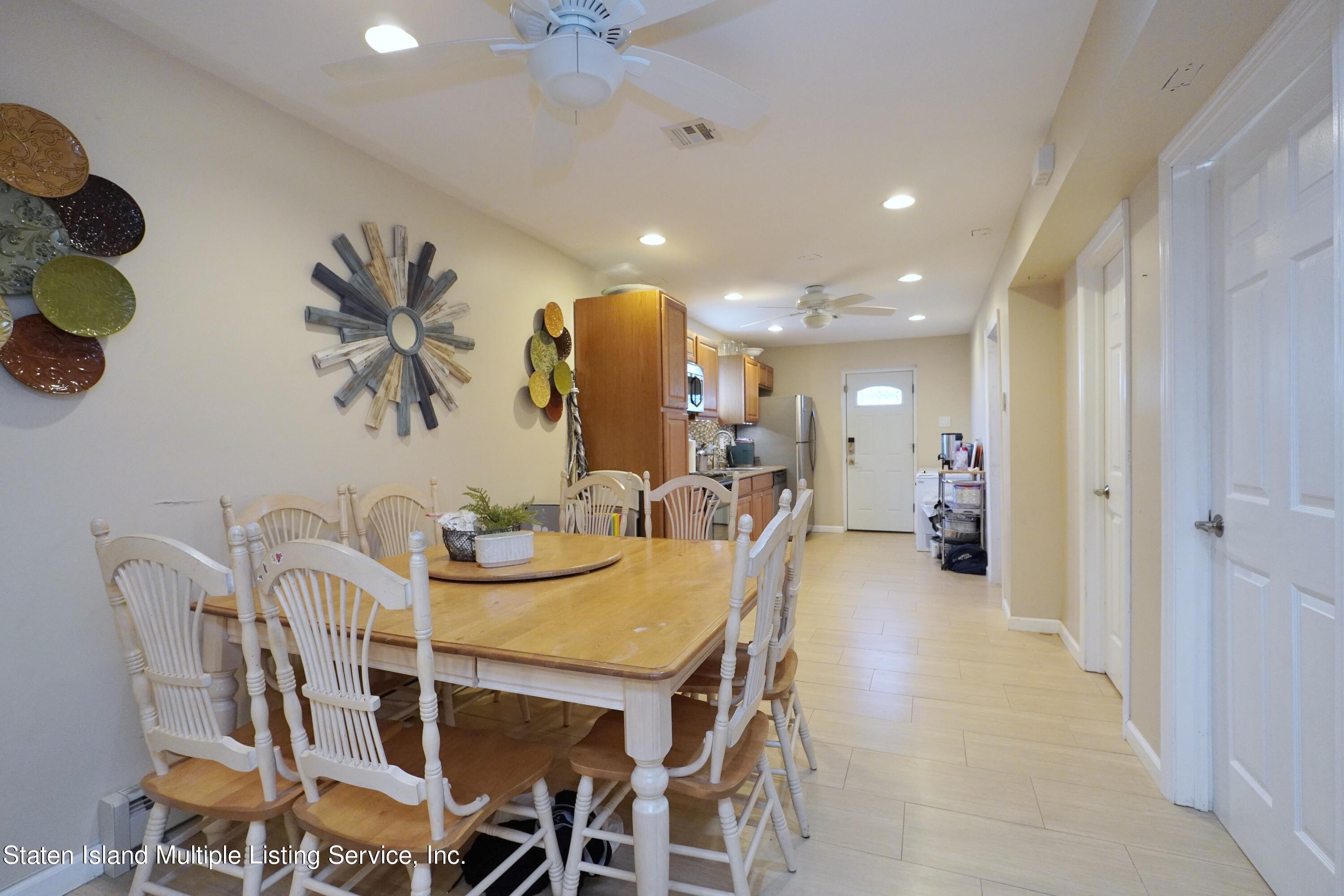 72 Middle Loop Road Staten Island, NY 10308 - Photo 15 of 38 a view of a dining room with furniture and chandelier