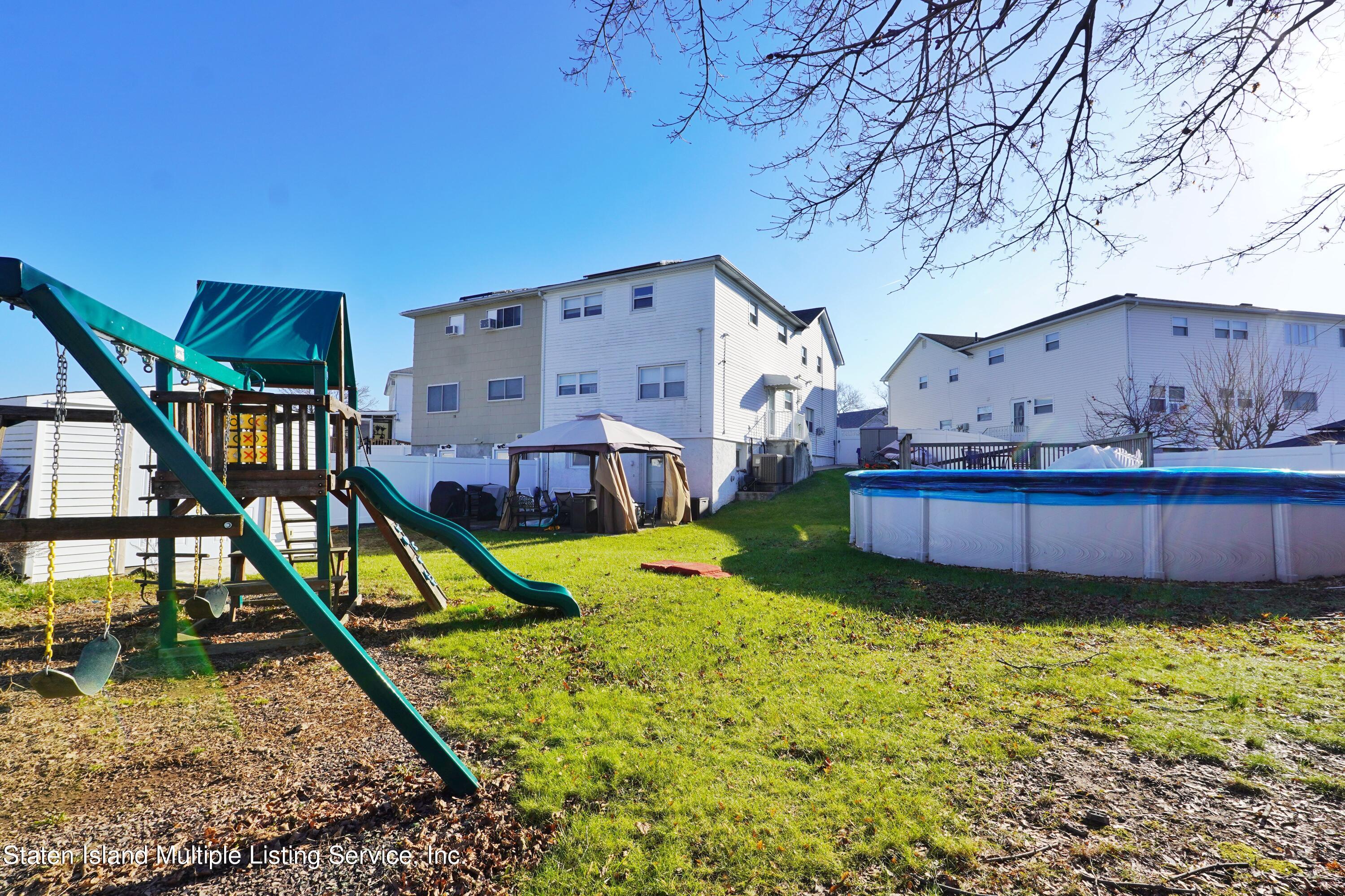 72 Middle Loop Road Staten Island, NY 10308 - Photo 16 of 38 a view of a house with backyard and sitting area