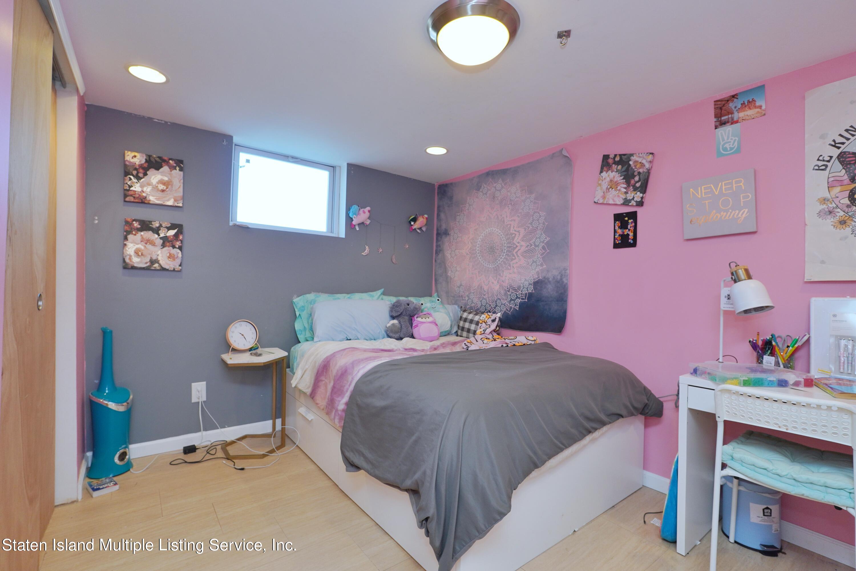 72 Middle Loop Road Staten Island, NY 10308 - Photo 17 of 38 a bedroom with a bed and a dresser