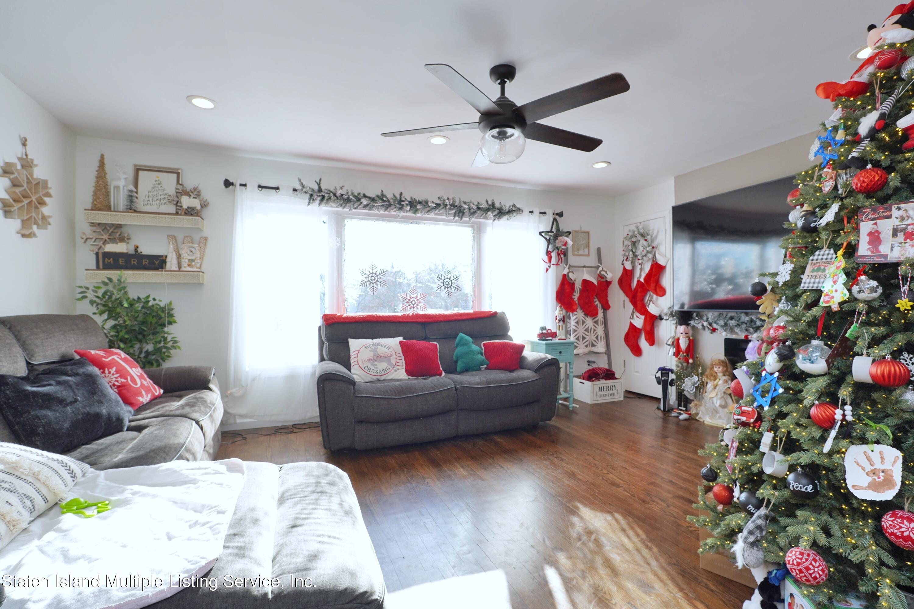 72 Middle Loop Road Staten Island, NY 10308 - Photo 20 of 38 a living room with furniture and flowers