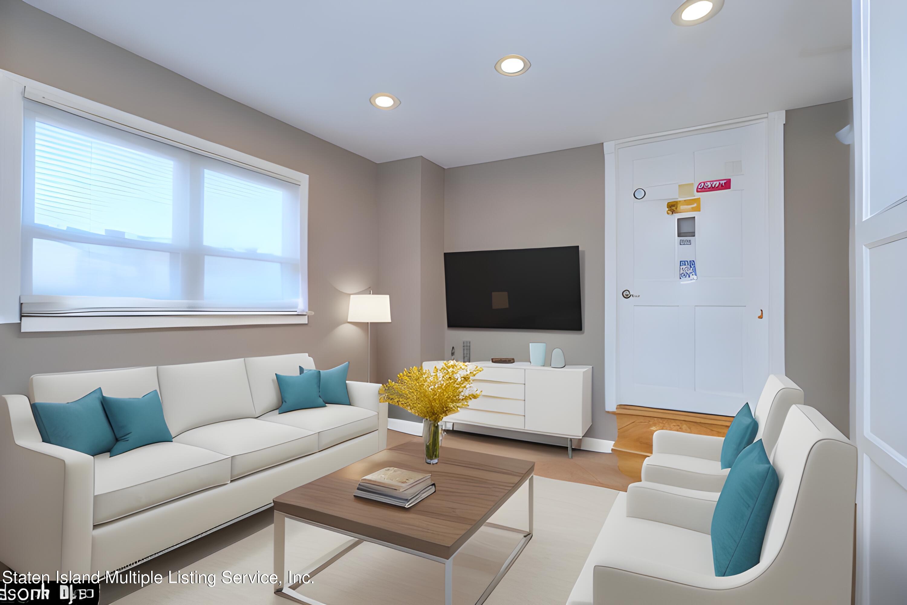 72 Middle Loop Road Staten Island, NY 10308 - Photo 2 of 38 a living room with furniture and a flat screen tv