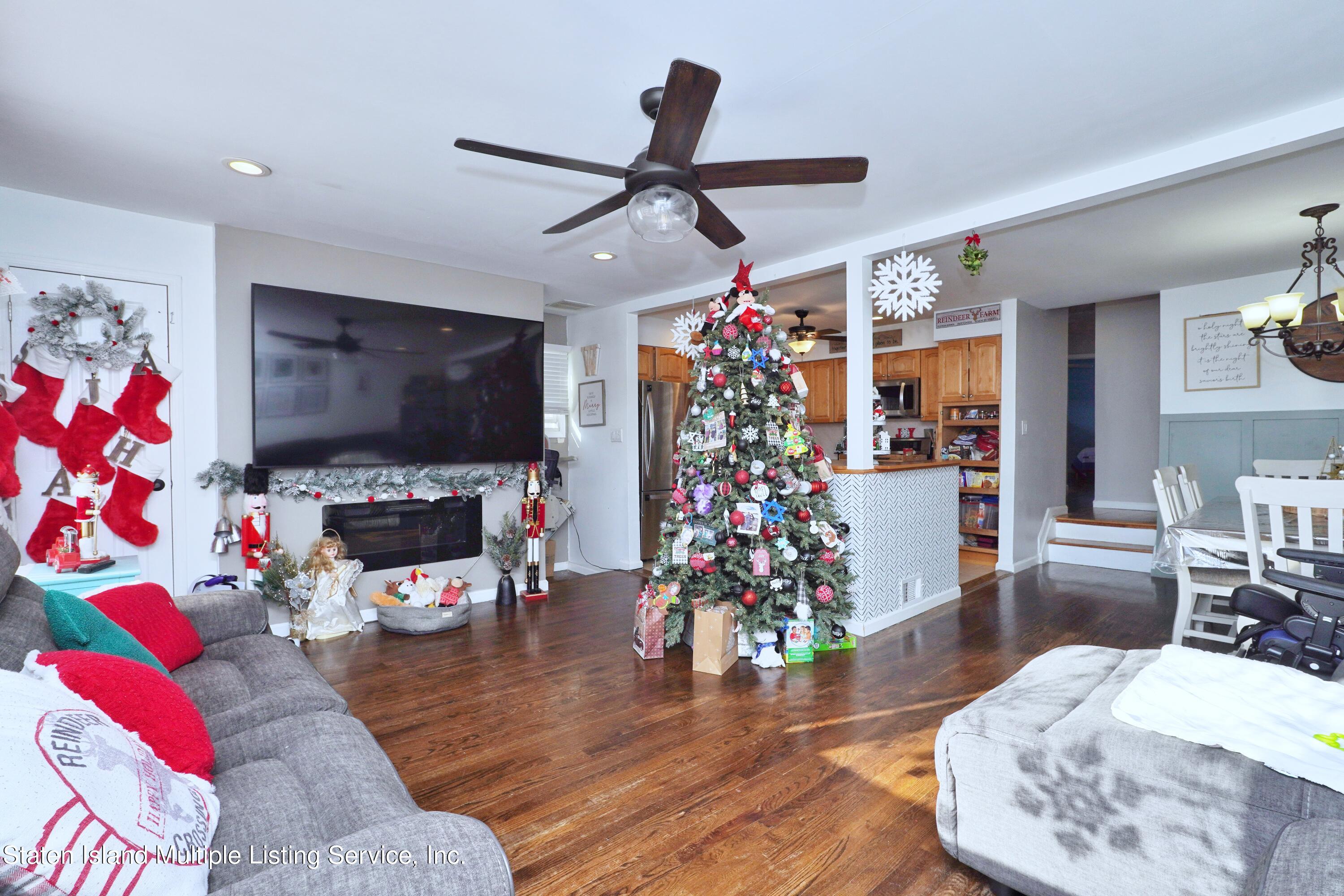 72 Middle Loop Road Staten Island, NY 10308 - Photo 22 of 38 a living room with furniture and a flat screen tv