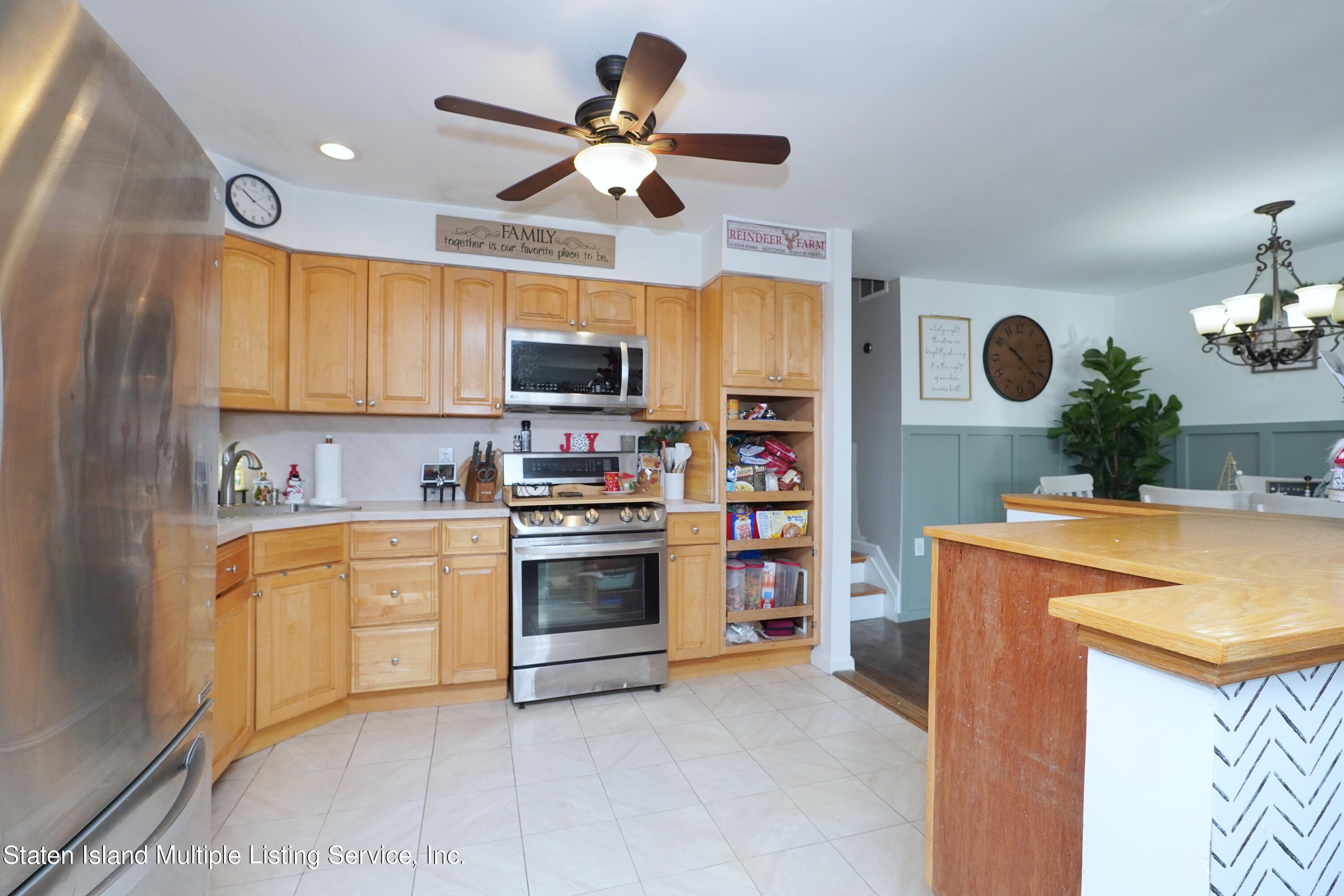 72 Middle Loop Road Staten Island, NY 10308 - Photo 26 of 38 a kitchen with stainless steel appliances granite countertop a sink a stove and a refrigerator