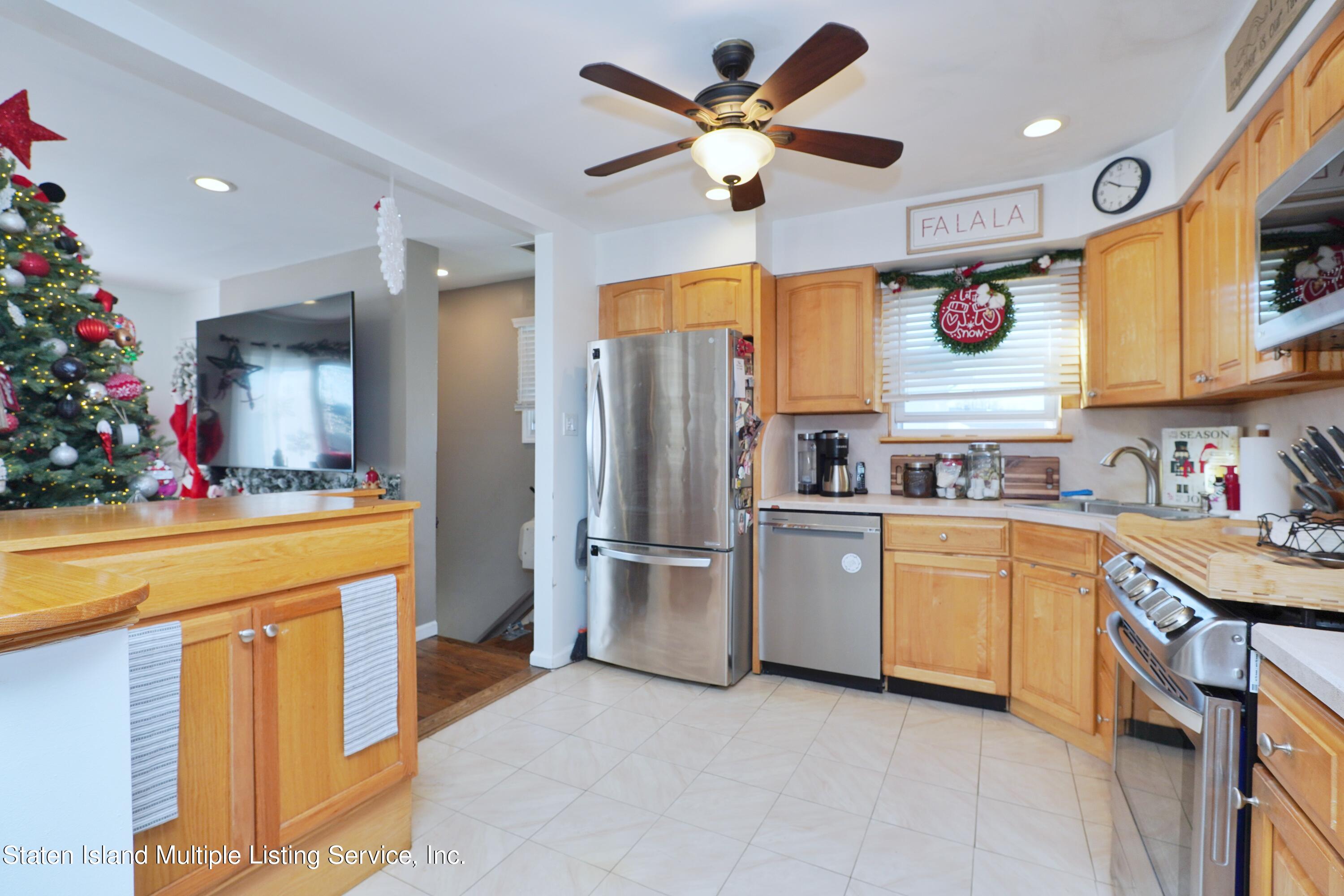 72 Middle Loop Road Staten Island, NY 10308 - Photo 28 of 38 a kitchen with stainless steel appliances granite countertop a sink a stove and a refrigerator