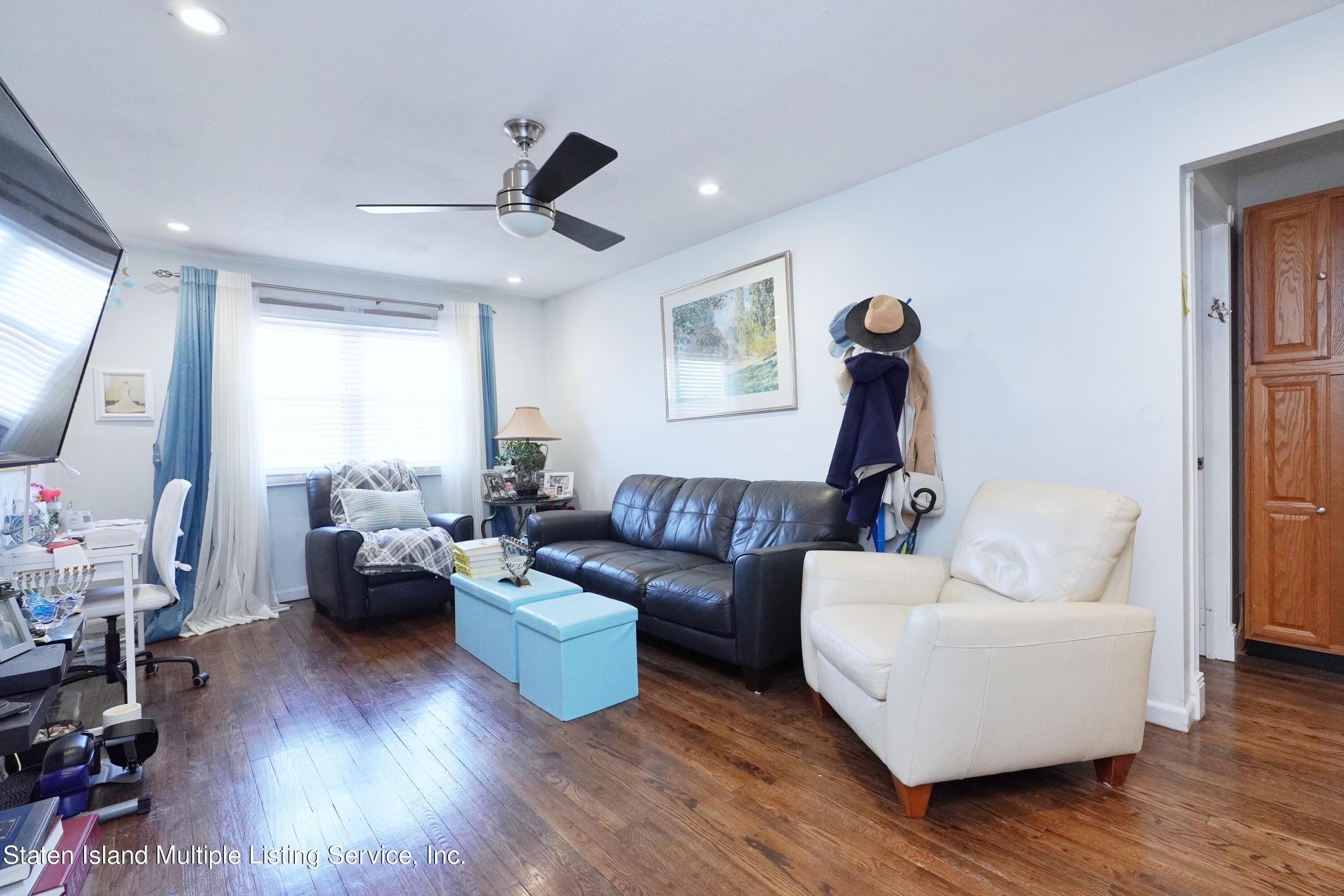 72 Middle Loop Road Staten Island, NY 10308 - Photo 3 of 38 a living room with furniture and a wooden floor