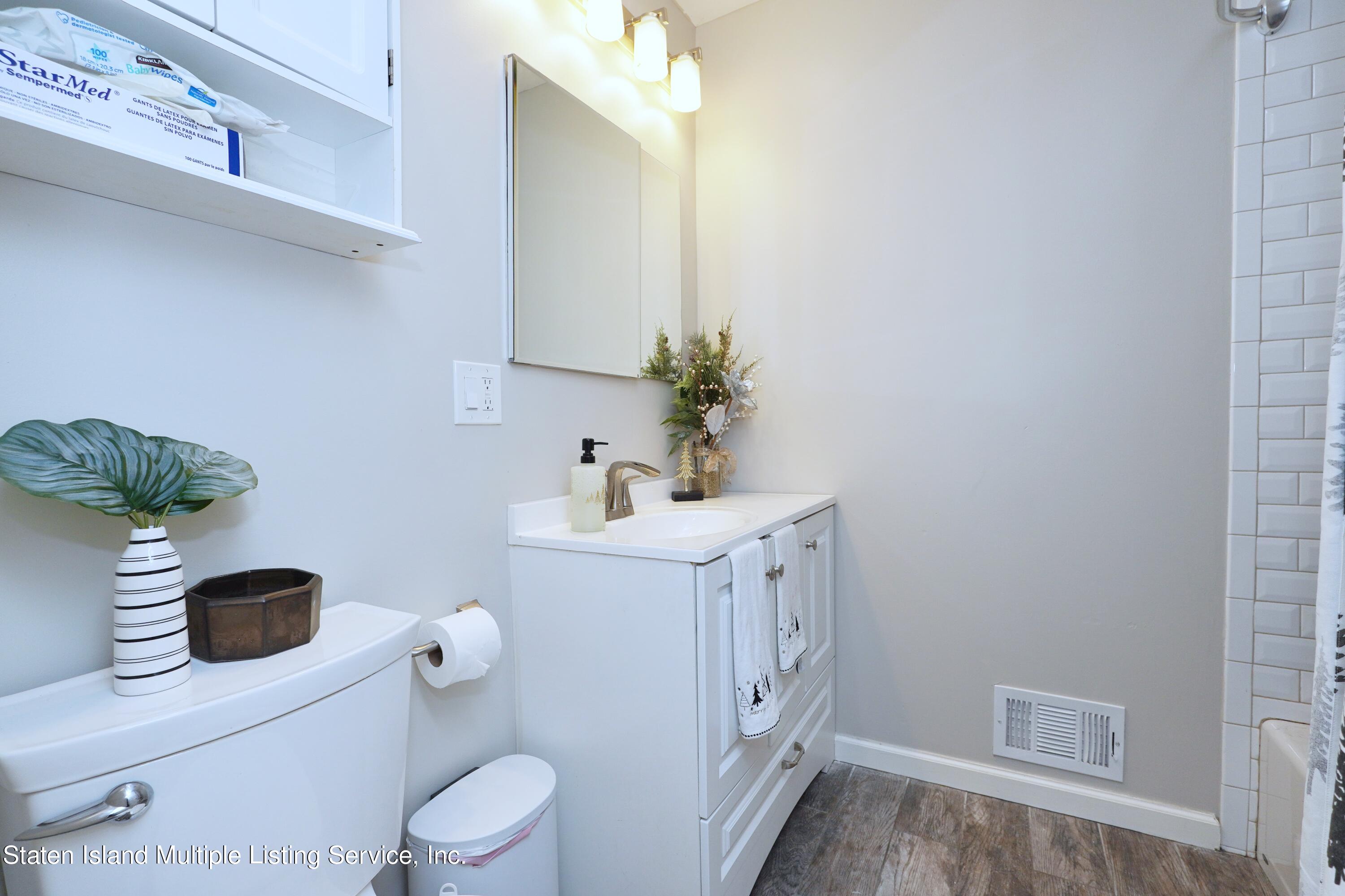 72 Middle Loop Road Staten Island, NY 10308 - Photo 31 of 38 a bathroom with a sink a toilet and shower
