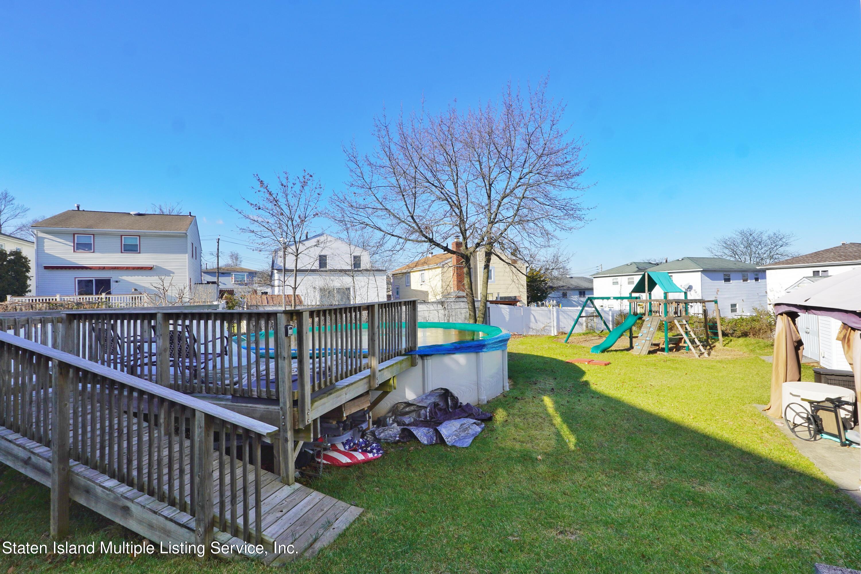 72 Middle Loop Road Staten Island, NY 10308 - Photo 36 of 38 a view of a porch with furniture and garden