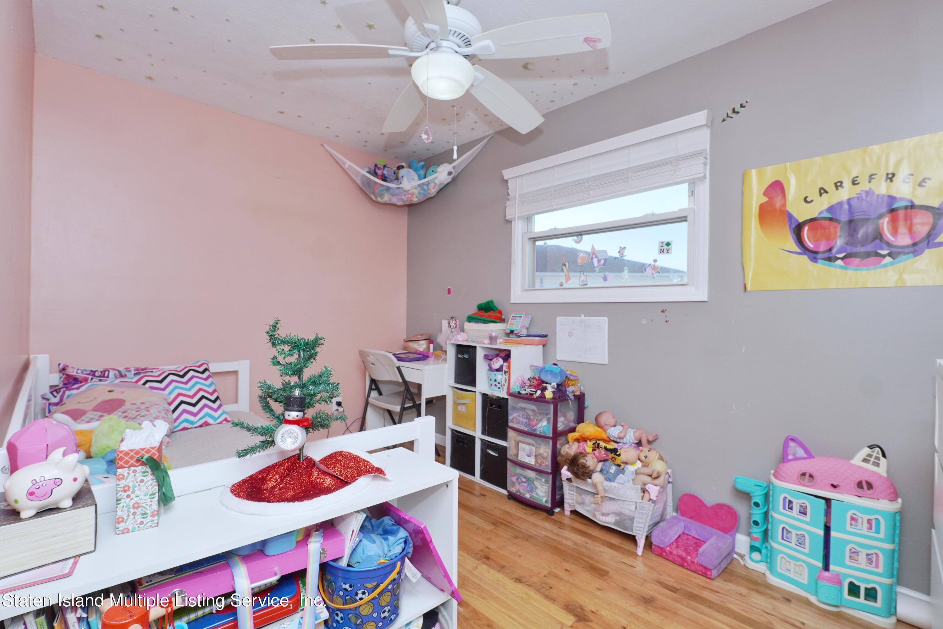 72 Middle Loop Road Staten Island, NY 10308 - Photo 37 of 38 a room with furniture and wooden floor
