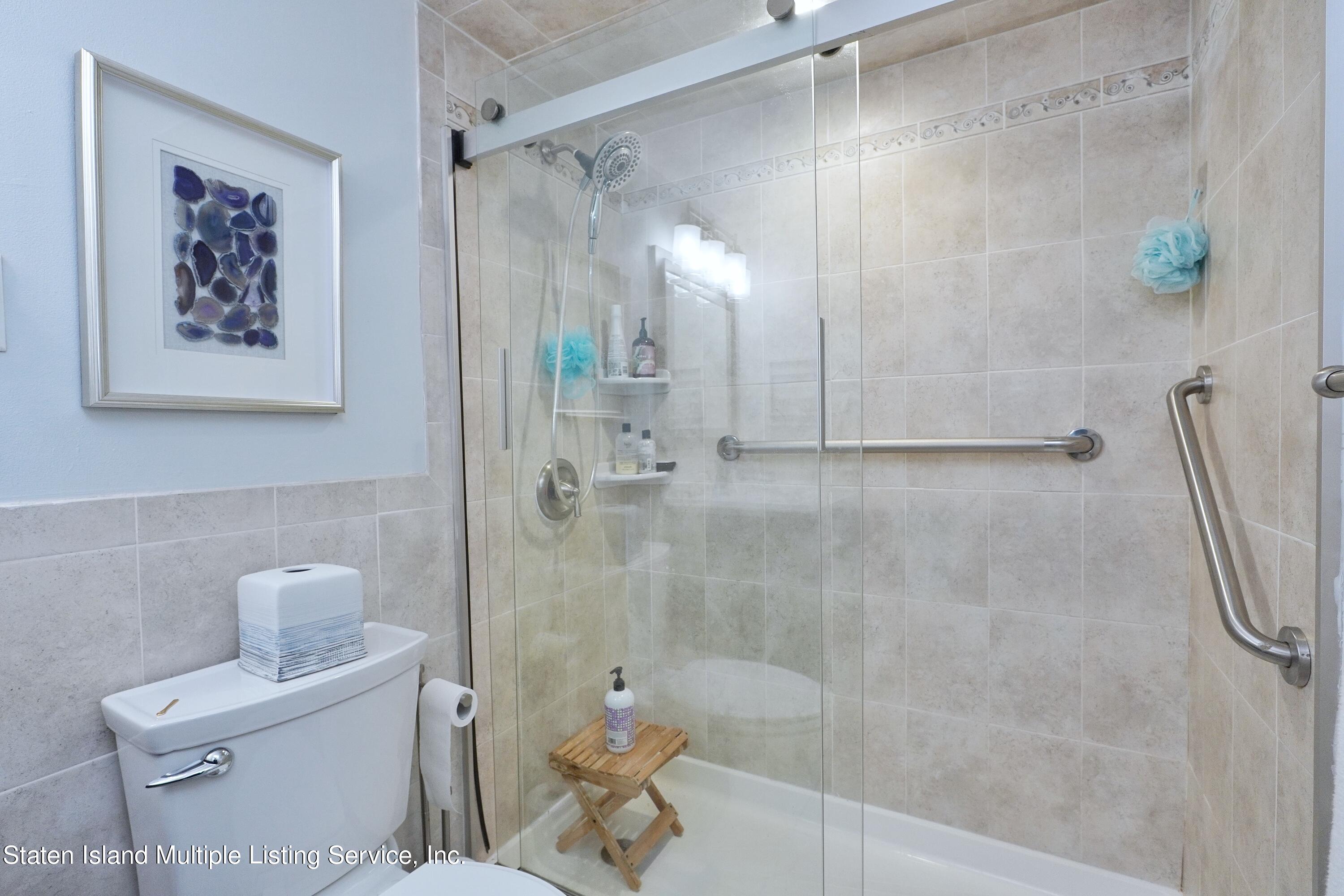 72 Middle Loop Road Staten Island, NY 10308 - Photo 7 of 38 a bathroom with a shower a toilet and a shower