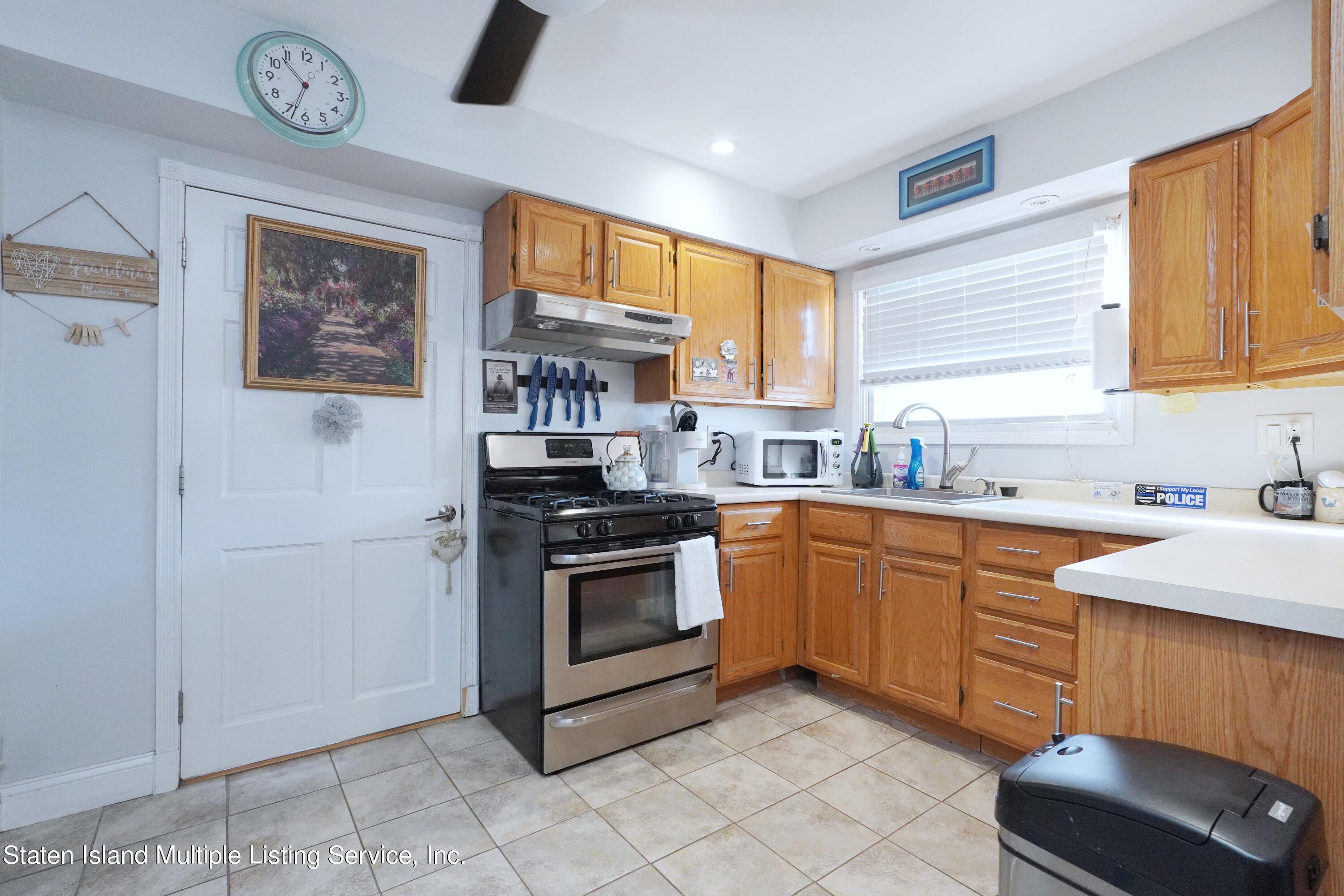 72 Middle Loop Road Staten Island, NY 10308 - Photo 9 of 38 a kitchen with stainless steel appliances granite countertop a stove a sink and a refrigerator