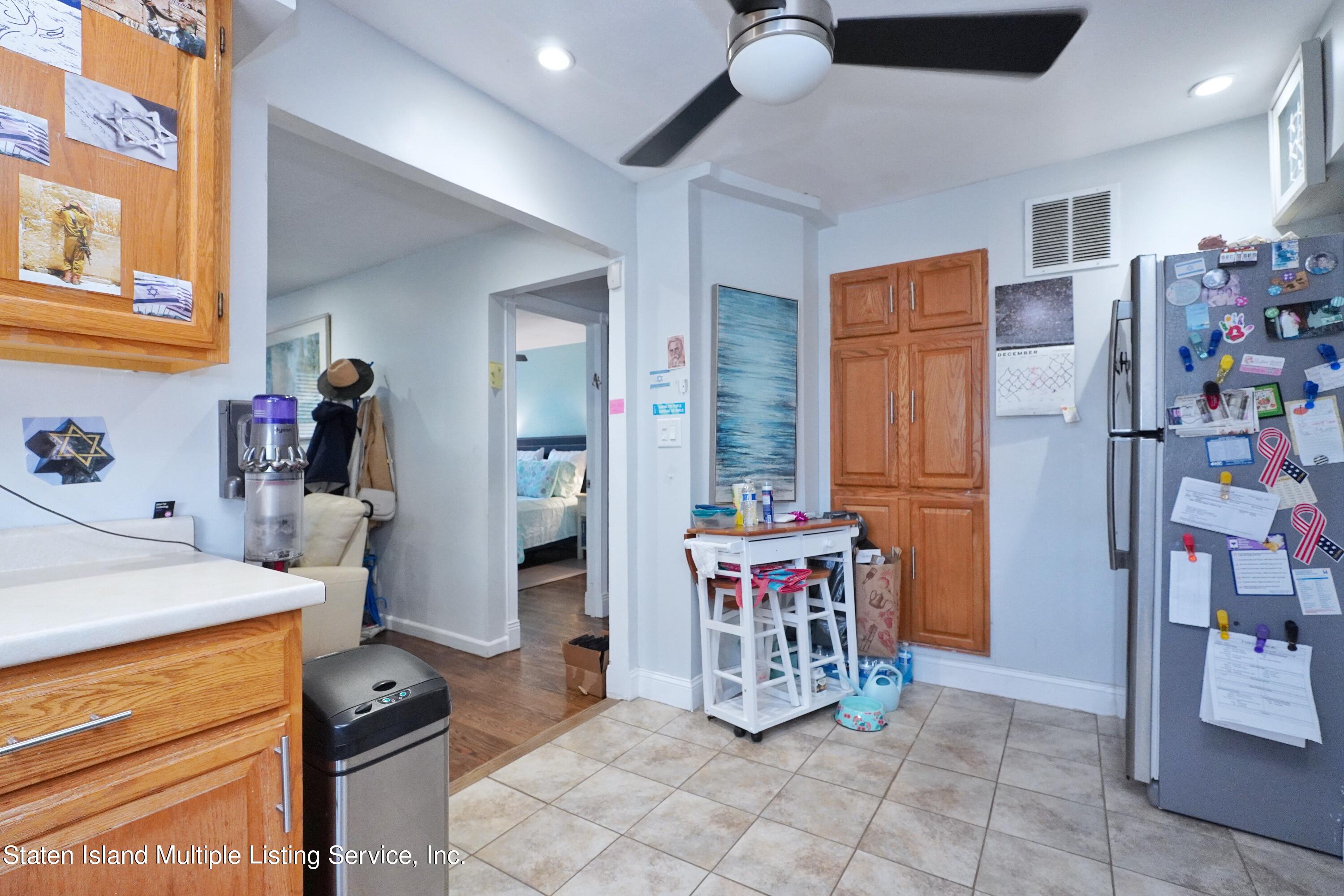 72 Middle Loop Road Staten Island, NY 10308 - Photo 10 of 38 a kitchen with stainless steel appliances kitchen island granite countertop a refrigerator and a stove top oven