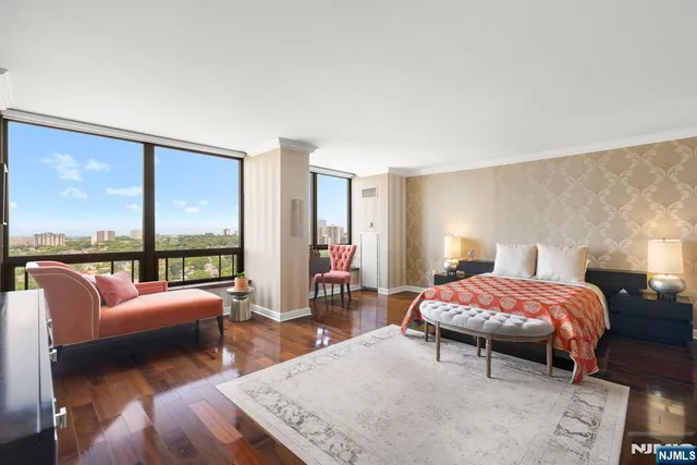 a bedroom with furniture and a large window