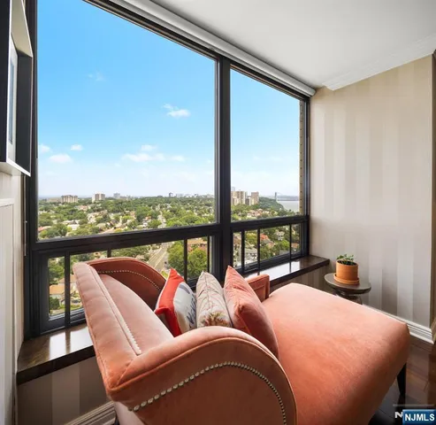 a balcony with furniture and a floor to ceiling window