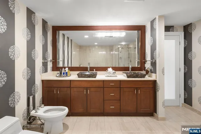 a bathroom with a toilet sink and mirror