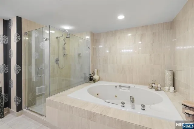 a bathroom with a bathtub and a shower