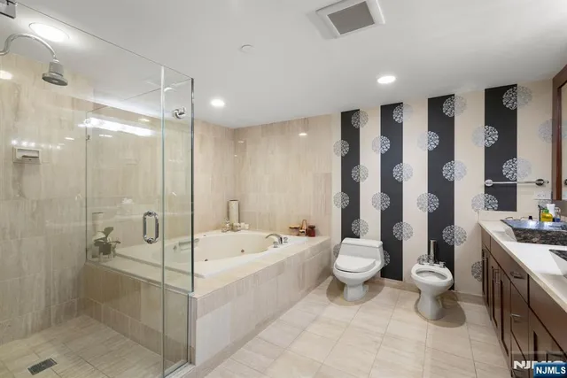 a bathroom with a double vanity sink toilet and shower