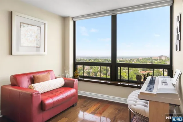 a living room with couch and a floor to ceiling window