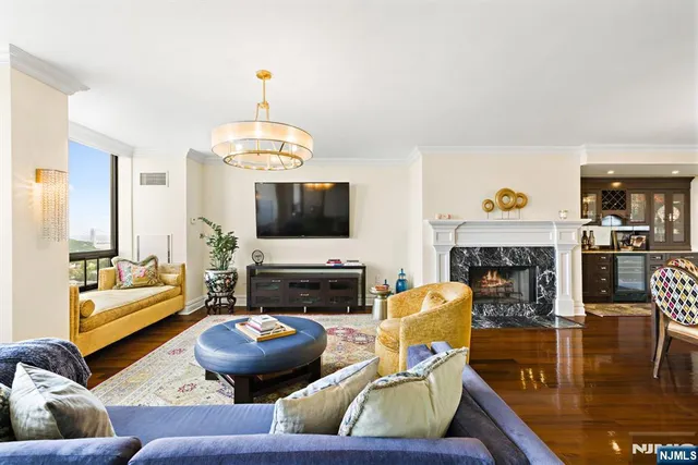 a living room with furniture a fireplace and a flat screen tv