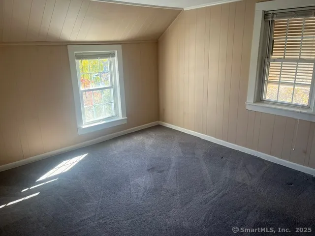 a view of a room with walk in closet and wooden floor