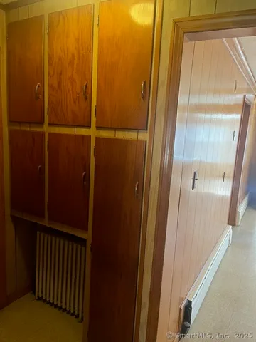 a small white house with a yard and garage