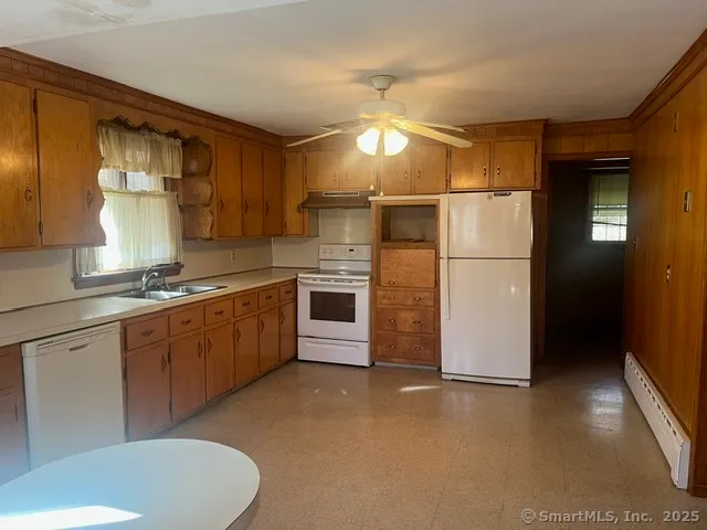 a kitchen with refrigerator cabinets and a sink