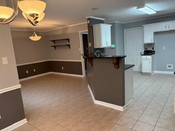a view of a refrigerator a counter space and wooden floor