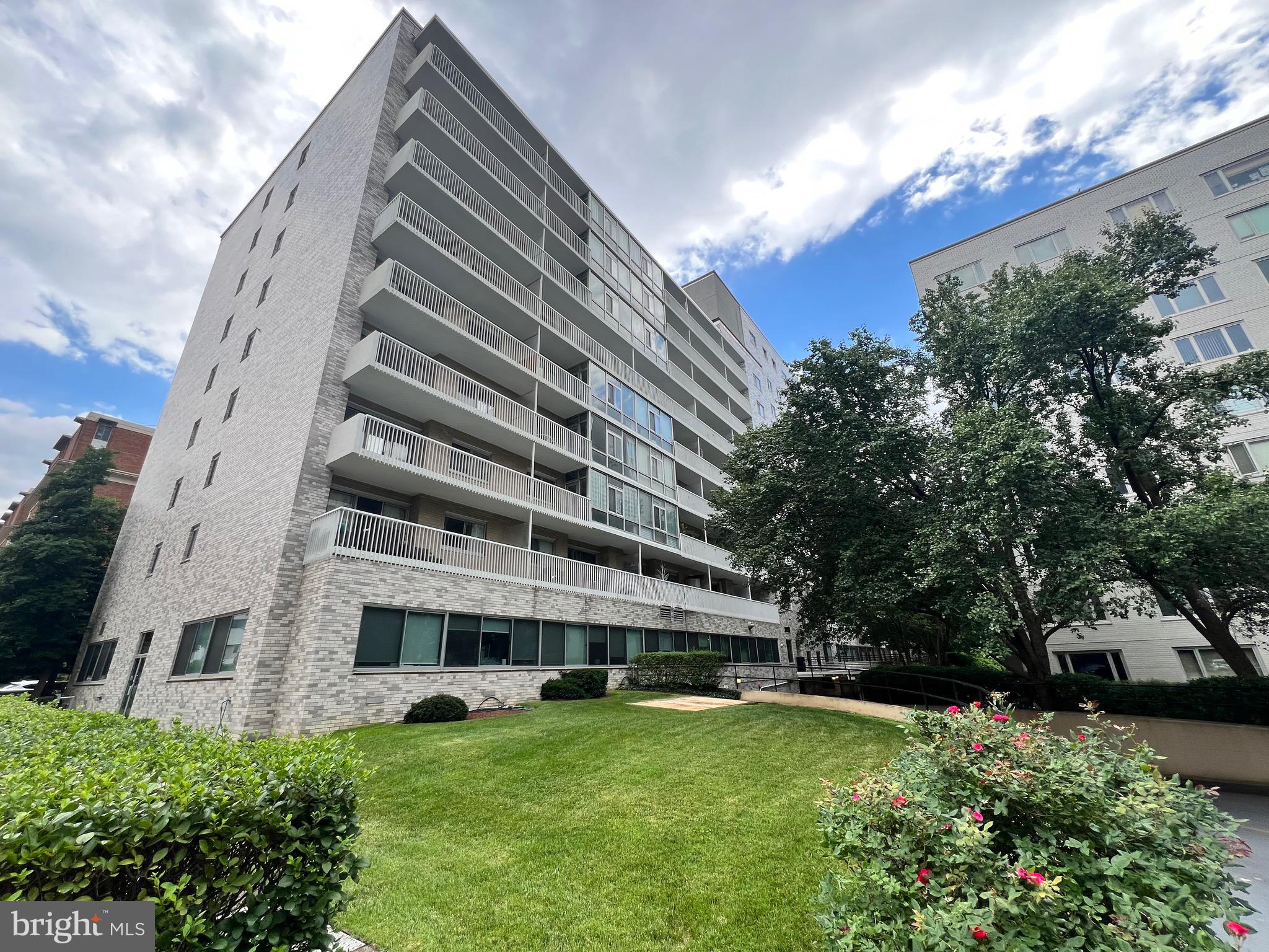 730 24th Street Northwest, Unit 703 Washington, DC 20037 - Photo 2 of 10 a view of a large building with a big yard and large trees