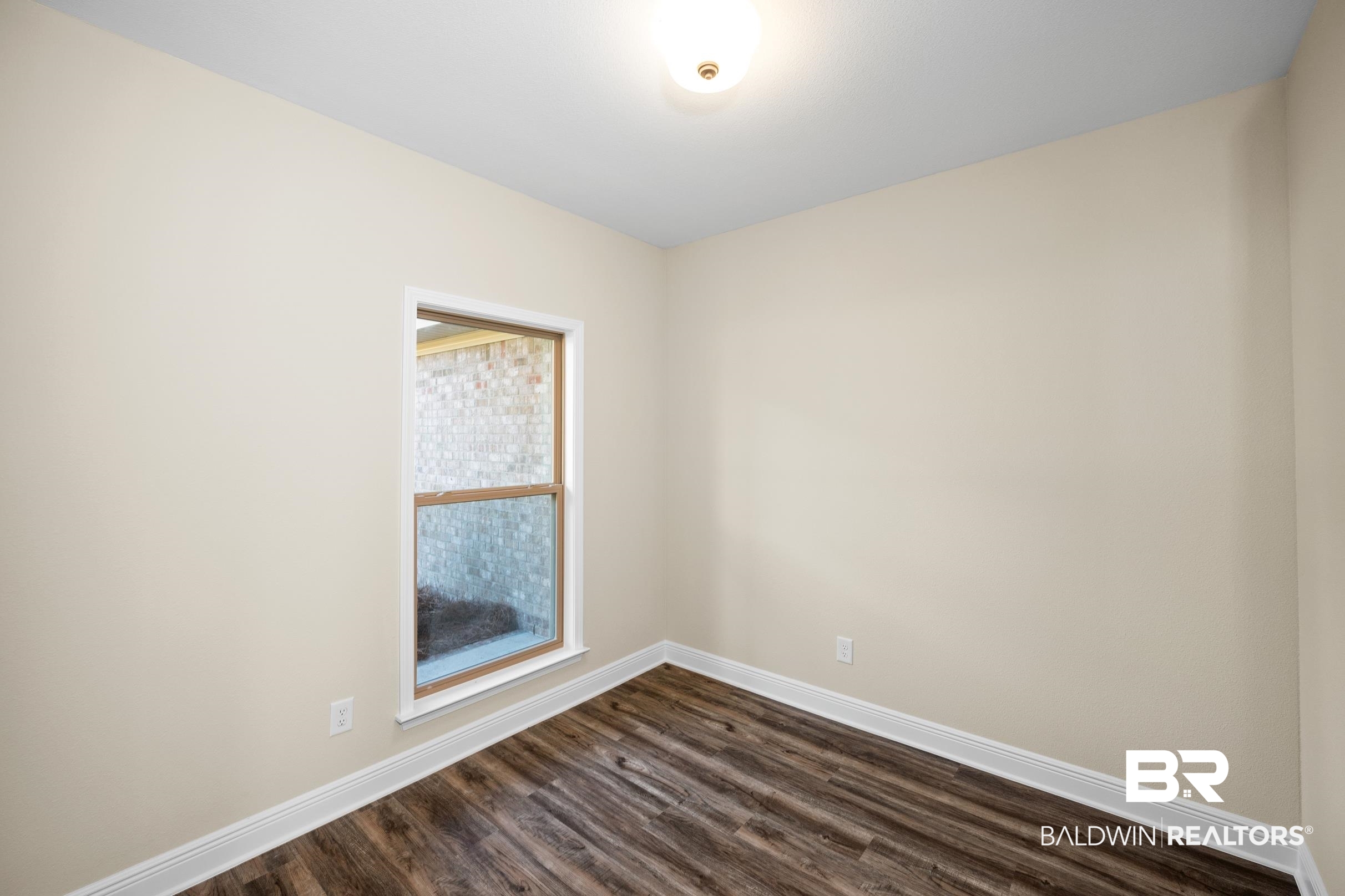 12833 Ward Road West Stapleton, AL 36578 - Photo 11 of 27 Unfurnished room featuring baseboards and dark wood-type flooring