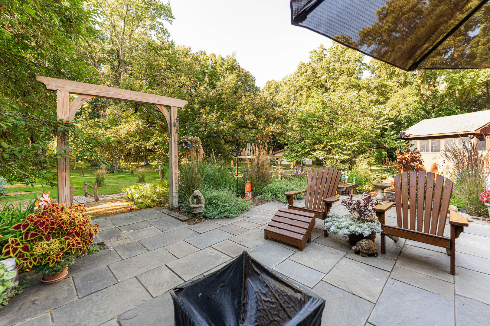 4060 Old State Road Kirkland, IL 60146 - Photo 32 of 51 a view of a patio with couches table and chairs and potted plants