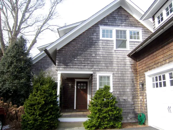 a front view of a house with plants