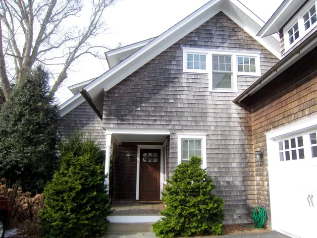 a front view of a house with plants