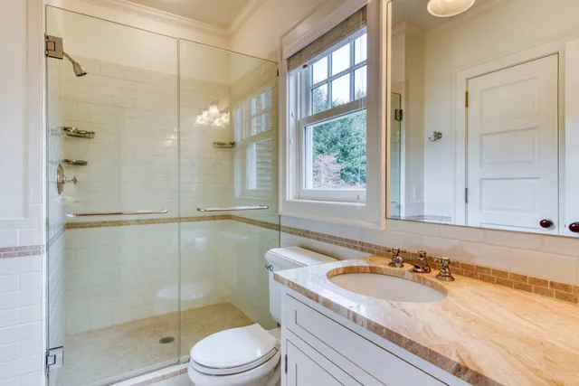 a bathroom with a sink toilet and shower