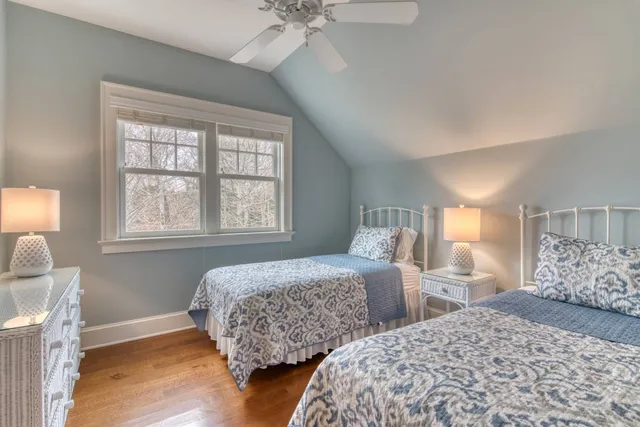 a bedroom with two beds and a window