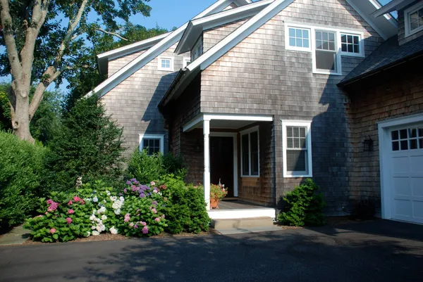 a front view of a house with a garden